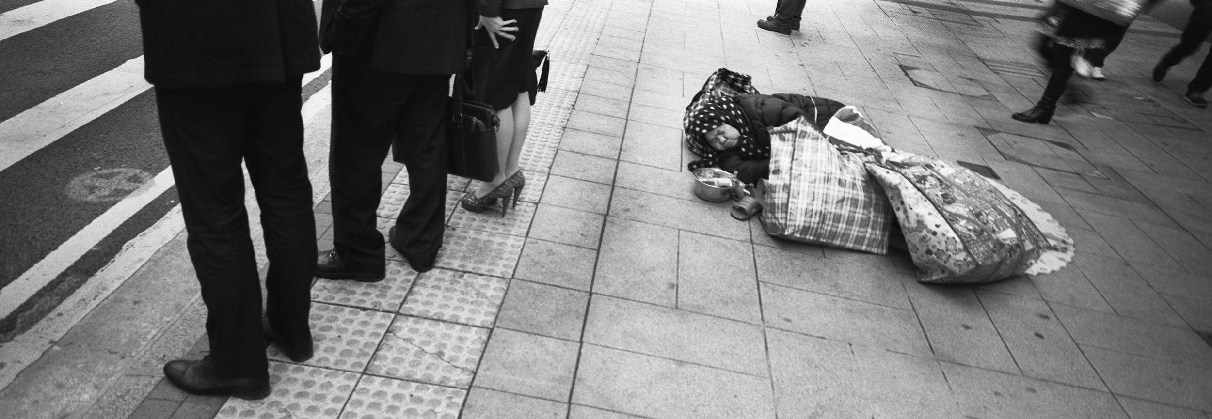  Business people and beggar. Hong Kong. 2014 