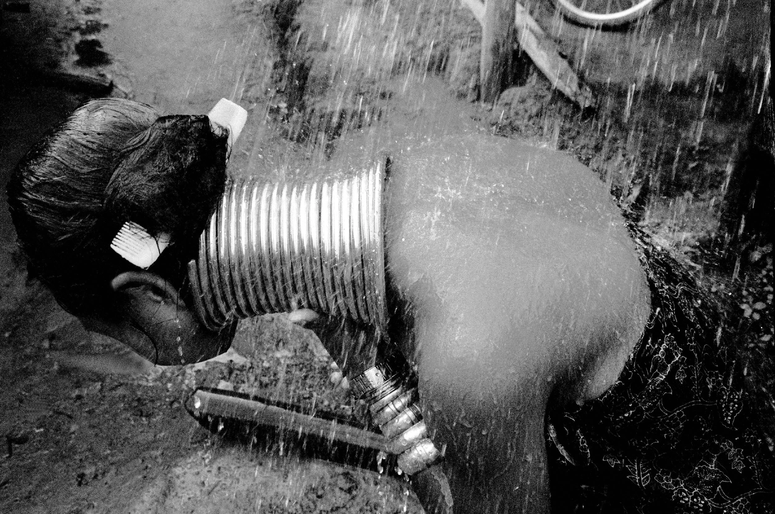  Ethnic Burmese Kayan woman bathing. Mae Hong Son province, Northern Thailand, in 2002 