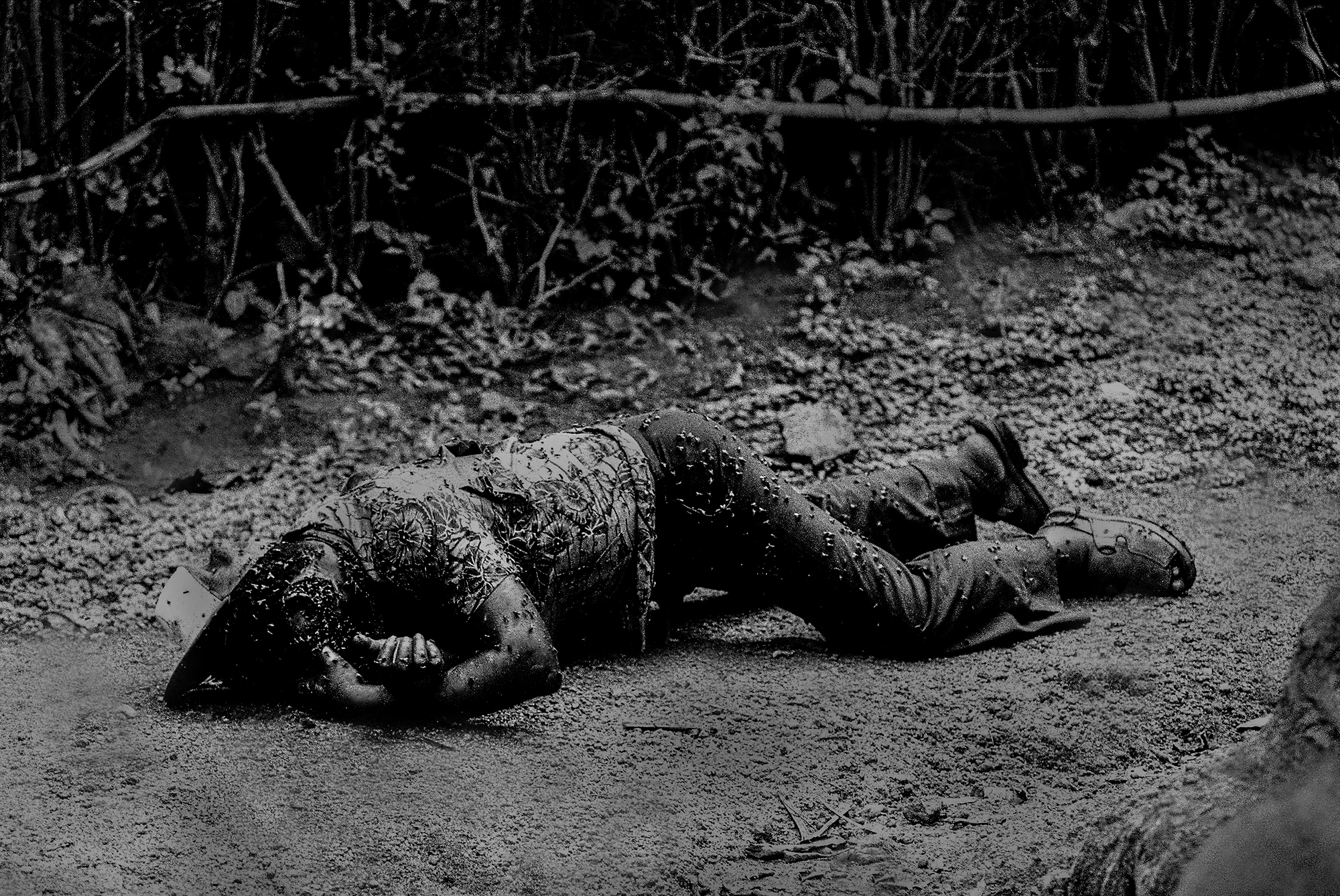  A Tutsi man felled in the front garden of his home. Many victims like this man appeared like still photographs - frozen in time -and peppered over the Rwandan landscape.  