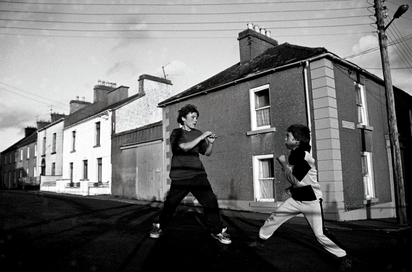  “Street Fighting” Settling differences on a street corner in Ballinasloe, County Galway, Ireland. 1990s 