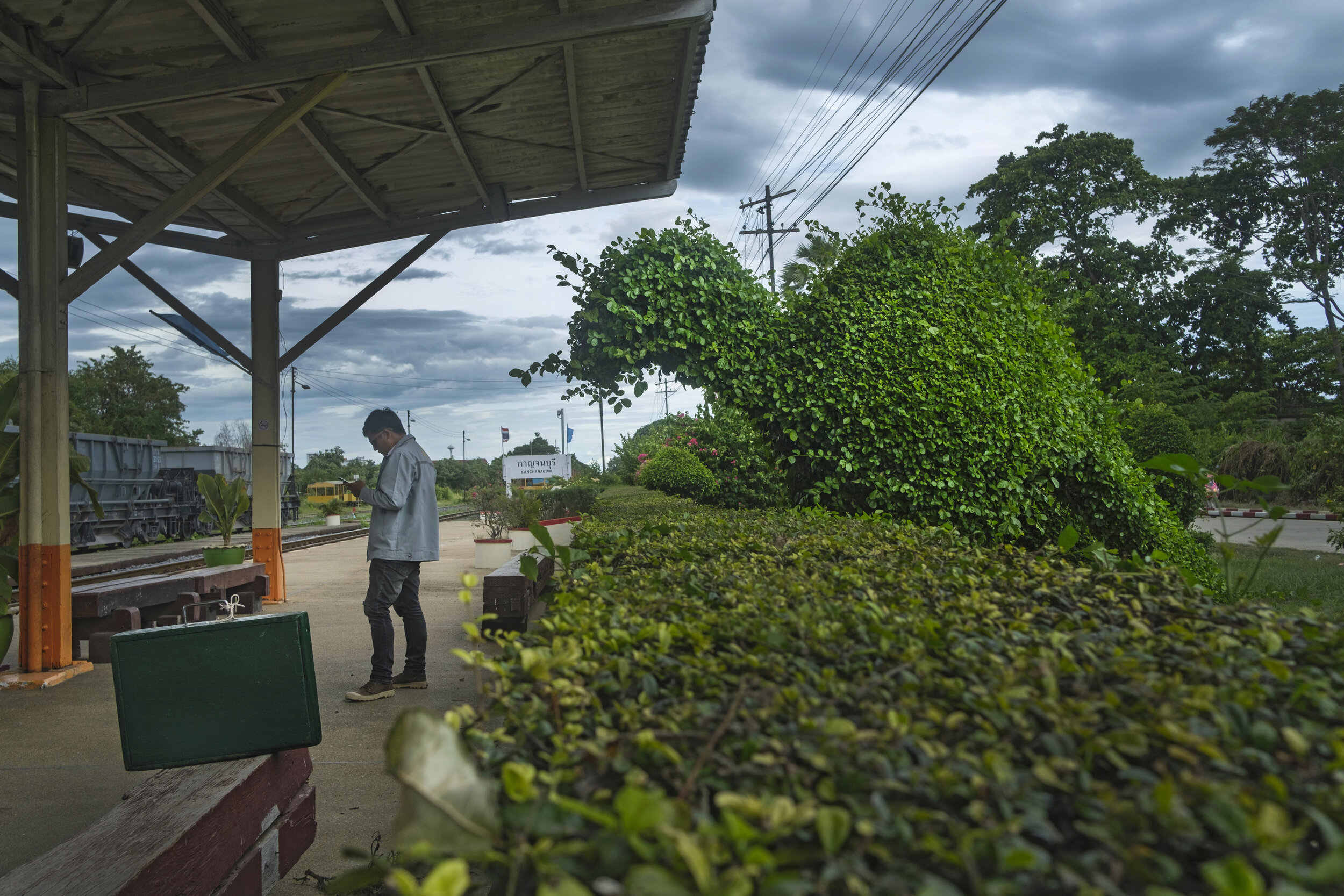  Man and “dinosaur” and mysterious green case at Kanchanaburi Train Station. 