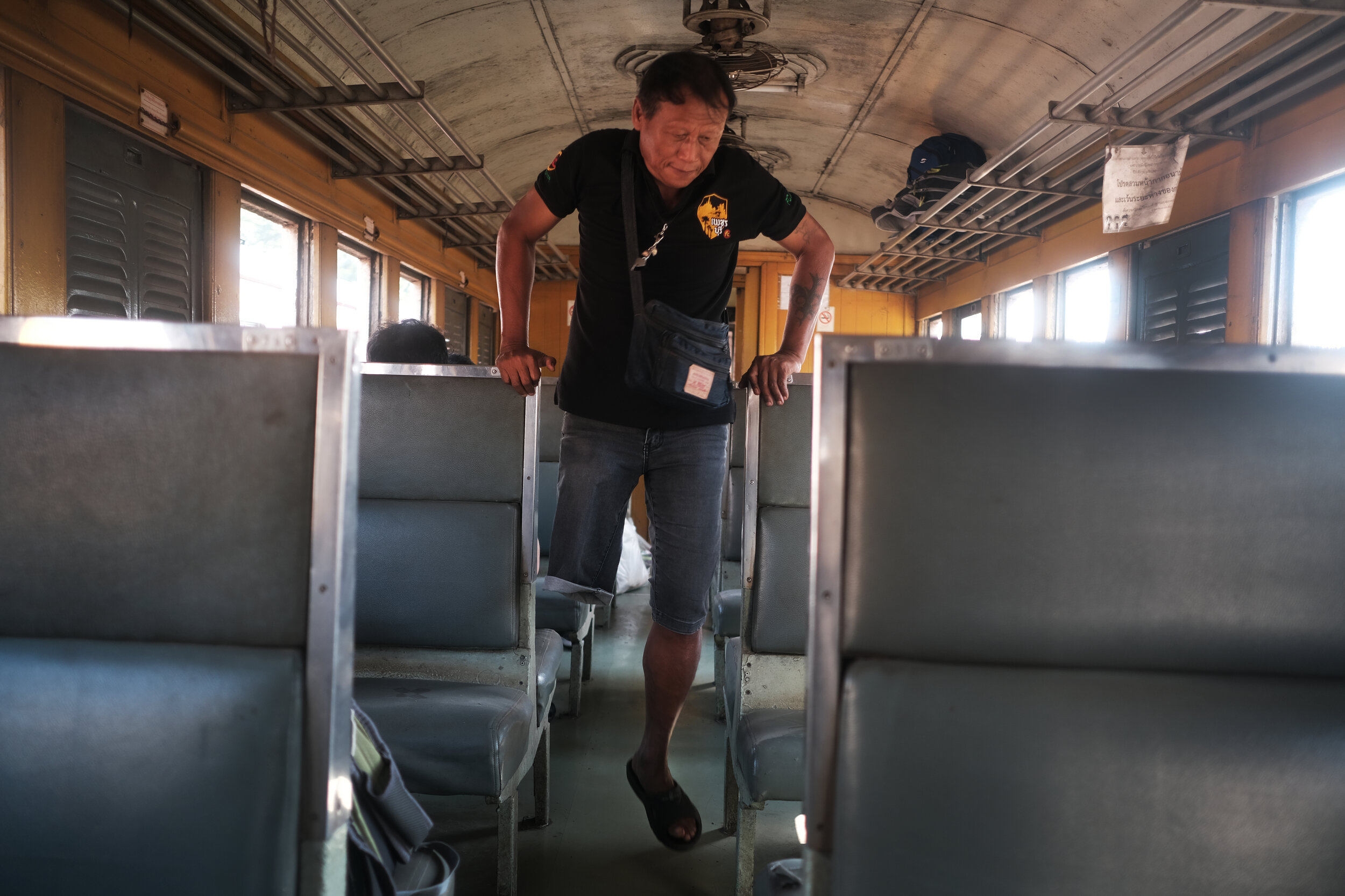  Passenger en route to Bangkok. The train travels along the infamous ‘death railway’ built by Allied prisoners of war during World War II. 