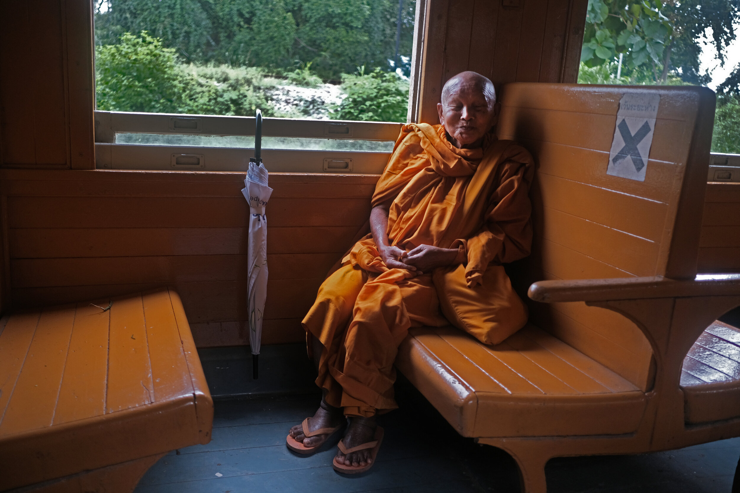  A Buddhist Monk en route to Kanchanaburi; we chatted, laughed, shared some food and stared out the window.      