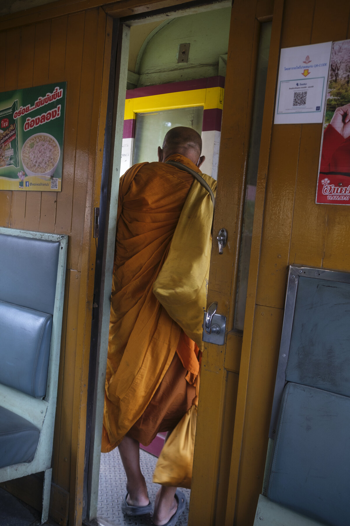  A Buddhist Monk disembarks; one of the many small stations between Bangkok and Kanchanaburi.       