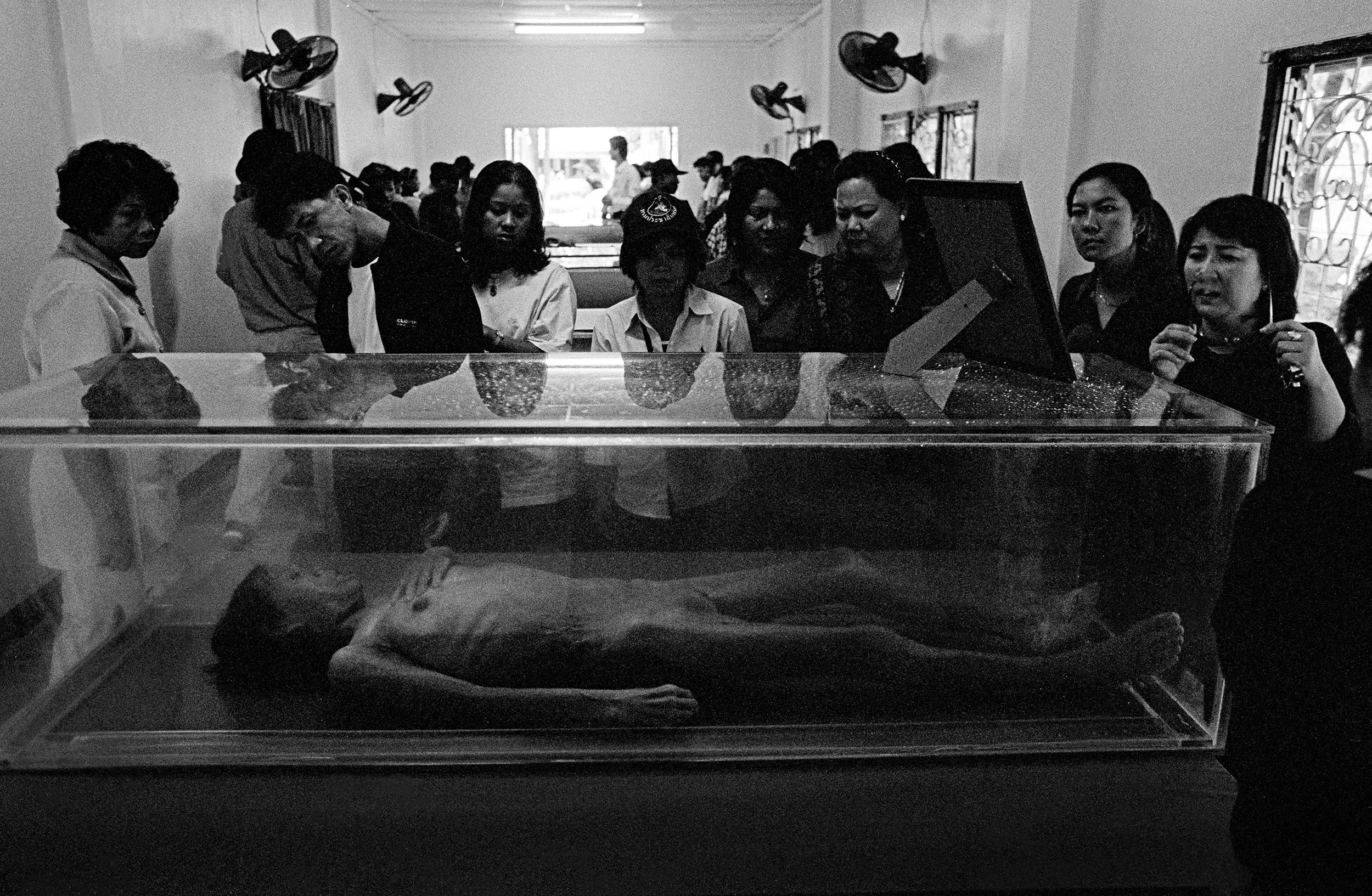  ‘Under Glass.’ A deceased woman is exhibited at the Wat Prabat Nampu AIDS Museum in Lopburi, north of Bangkok. Thailand. 2003.  