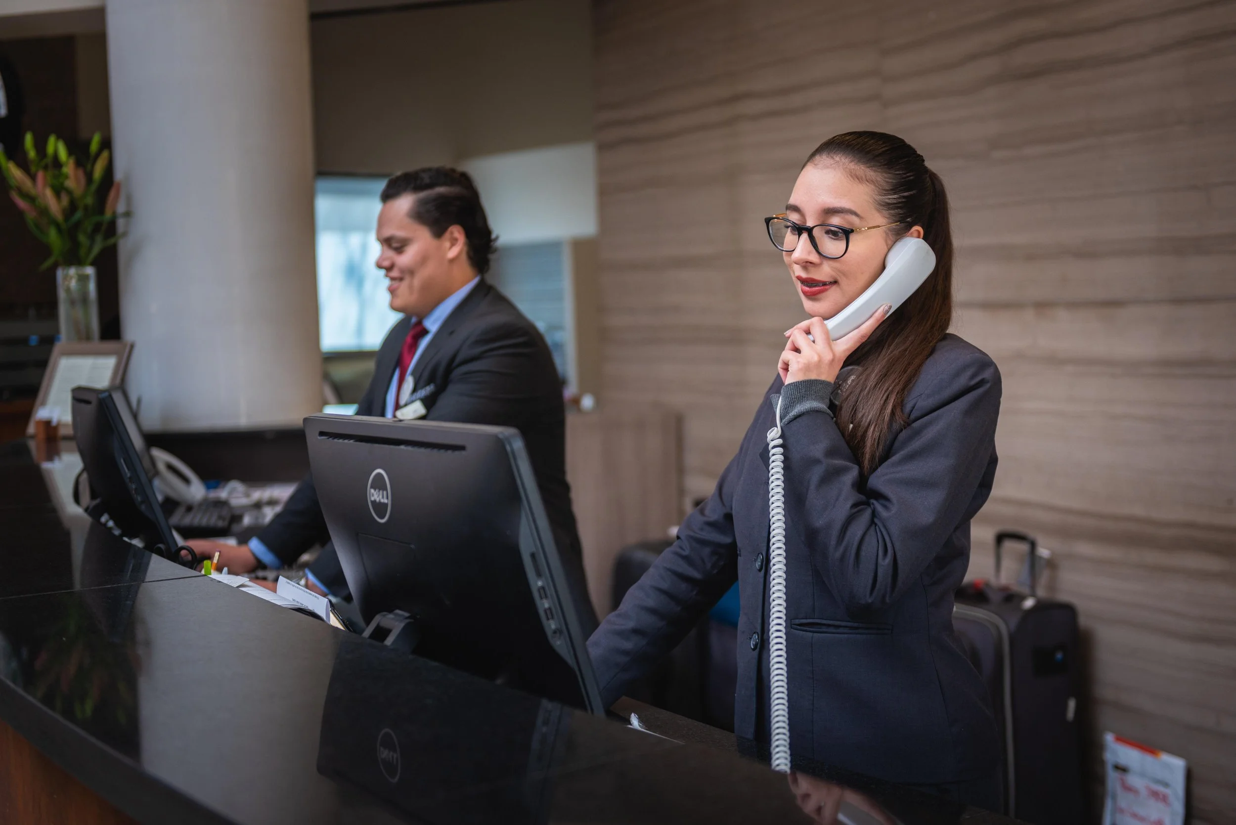 Receptionist on the phono in a hotel lobby