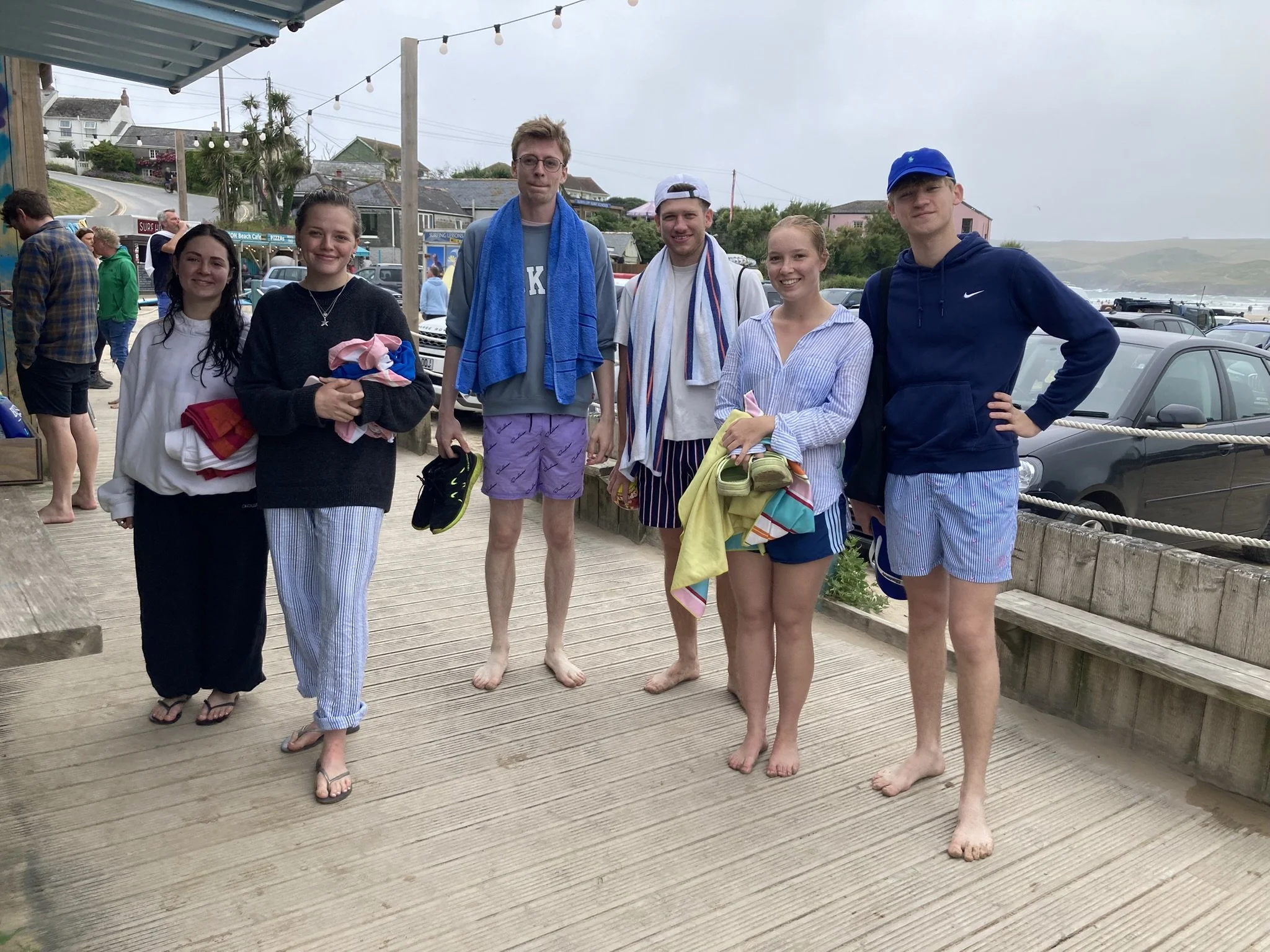 Young people enjoying their time off down at the beach cafe having been in for a swim.