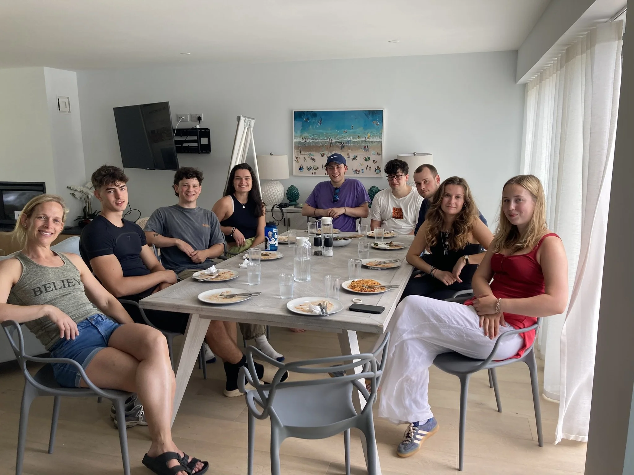 Group of syudents sitting around a table having eaten lunch together