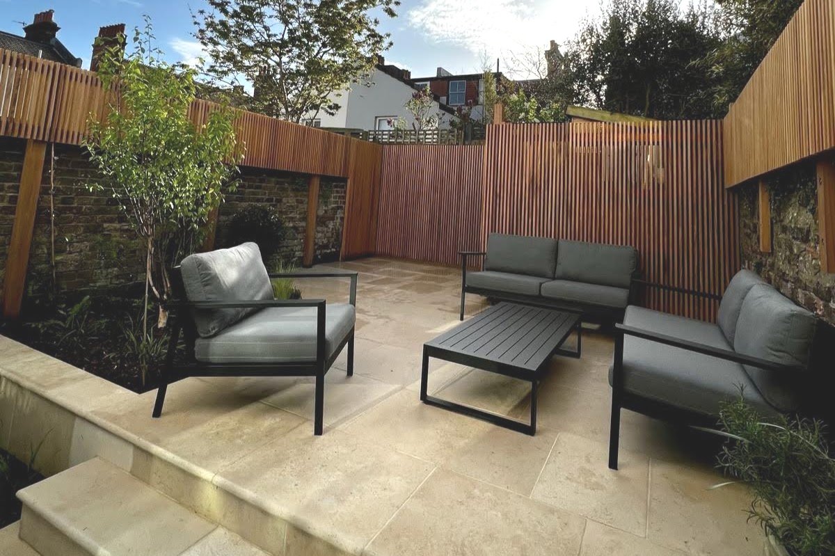 stylish social courtyard with limestone paving. garden design brighton