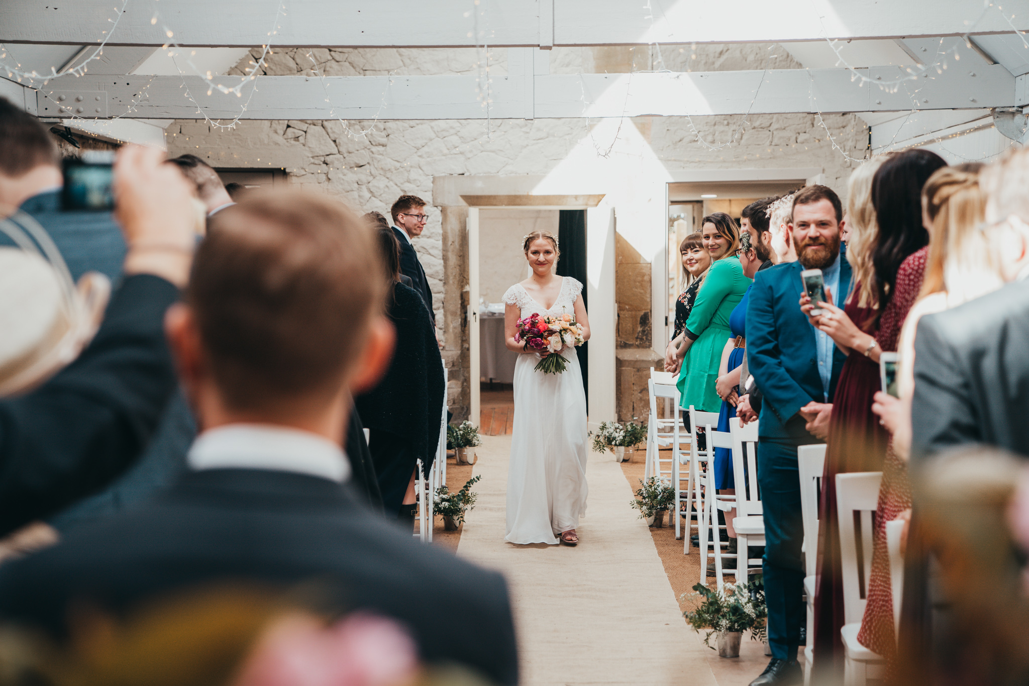 Bride with Flowers Walks down Aisle