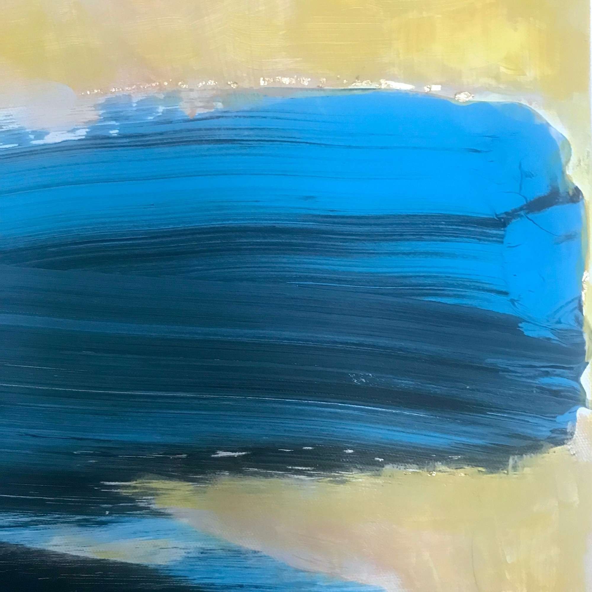 detail of abstract painting in blue and ochre with gold leaf