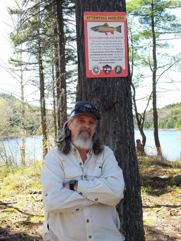 Native Fish Coalition National Vice Chair, Maine board member, and founding member Bob Mallard with the first State Heritage Fish sign posted. June 2018, Misery Pond, Misery TWP, Somerset County, Maine.