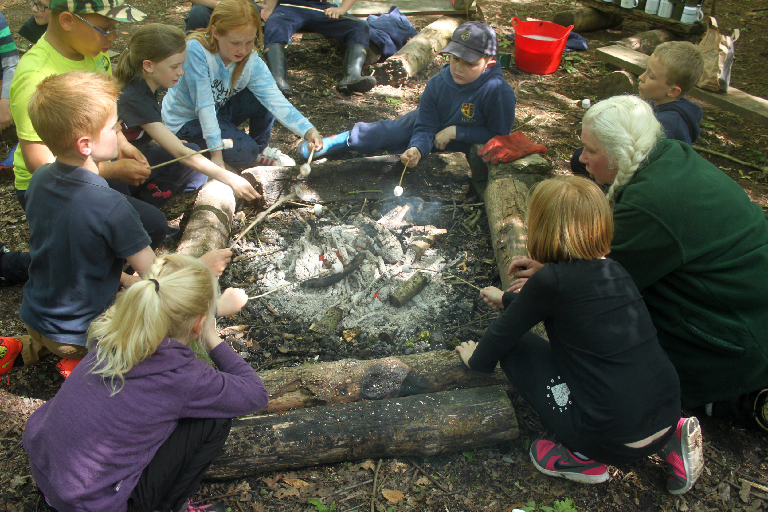 Group round fire with marshmallows.jpg