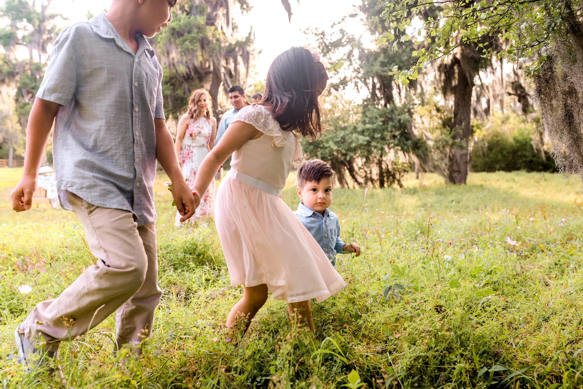 Outdoor Houston Family Photo Session with Golden Light, Mossy Trees, and Summer Sunlight.