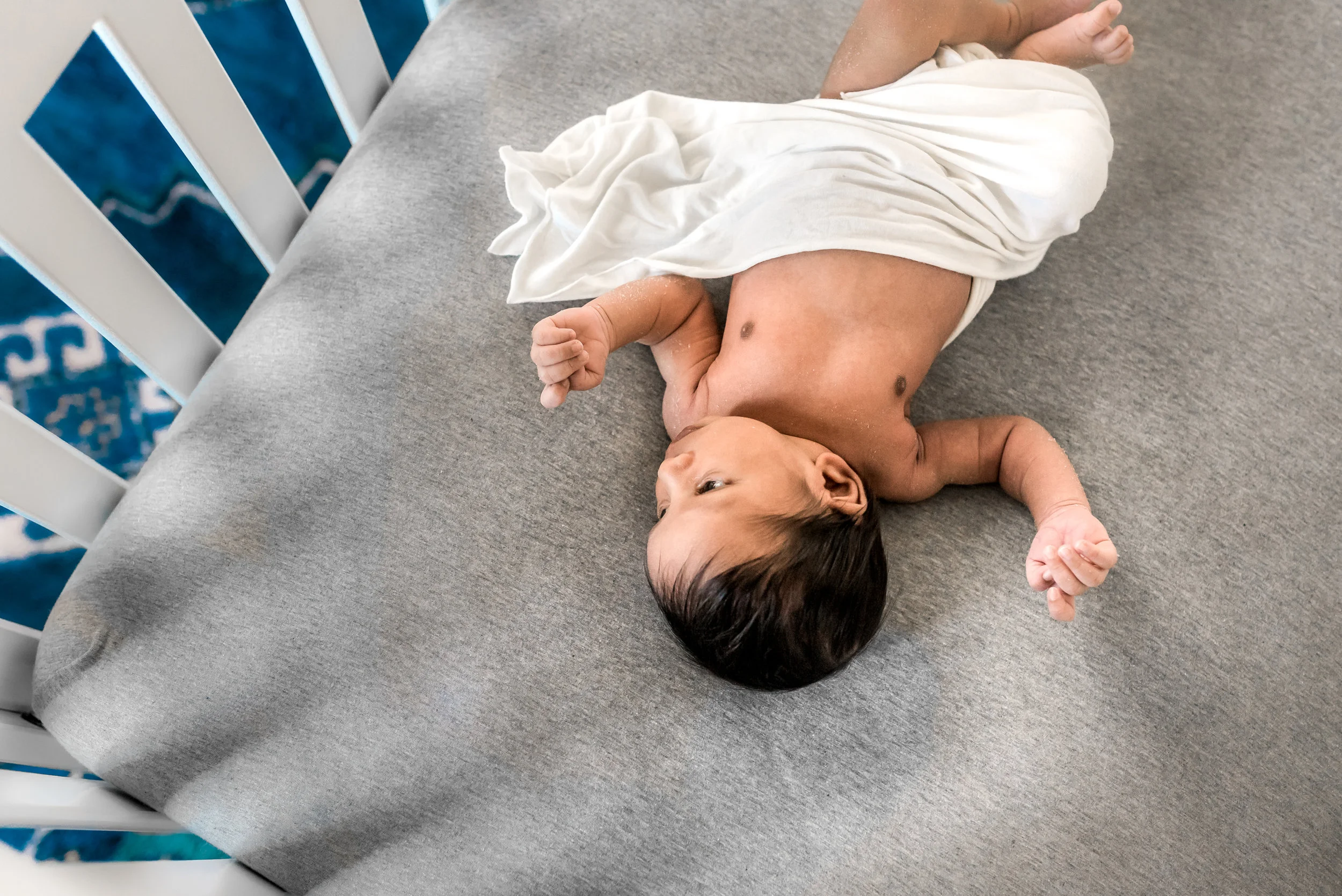 In home Houston Newborn Session with modern touches, boho accents, and vibrant colors.