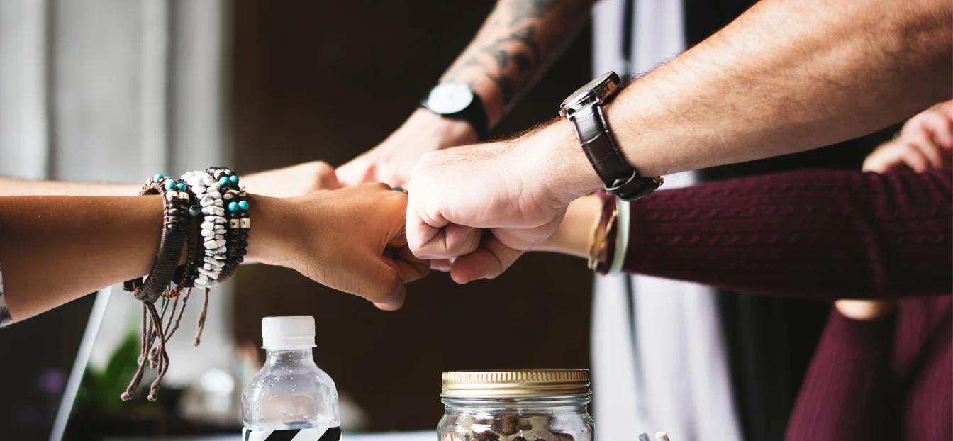 Coworkers fistbump.
