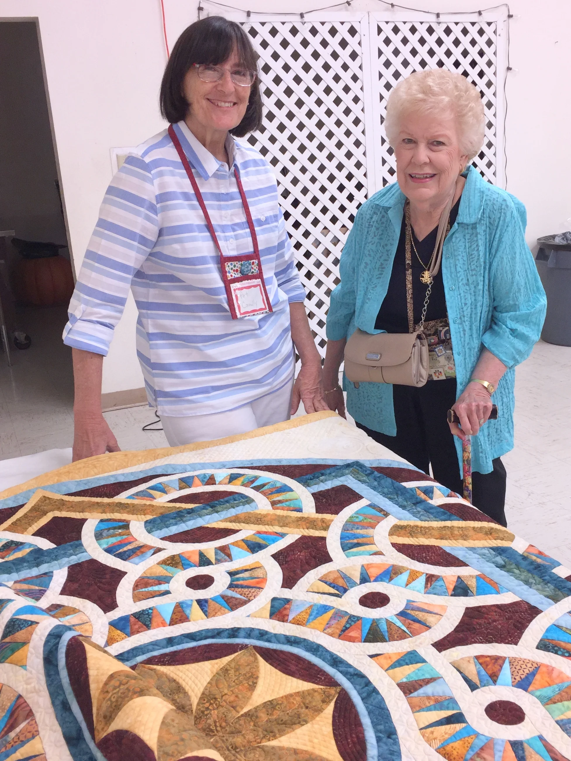 Lou Nelle George Admiring Pat Connally's Quilt
