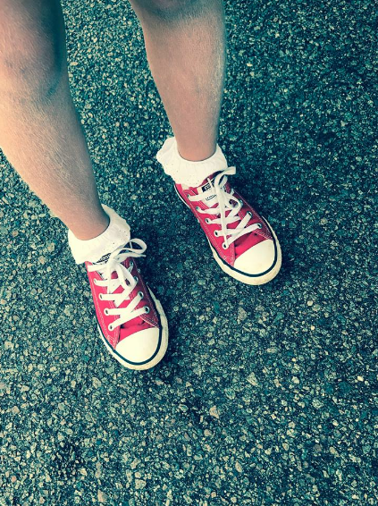 Stella Benson playing in her red sneakers