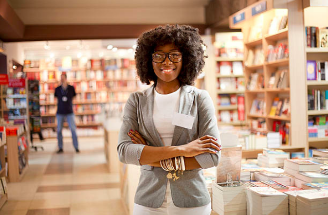 Woman Standing in Bookstore.png