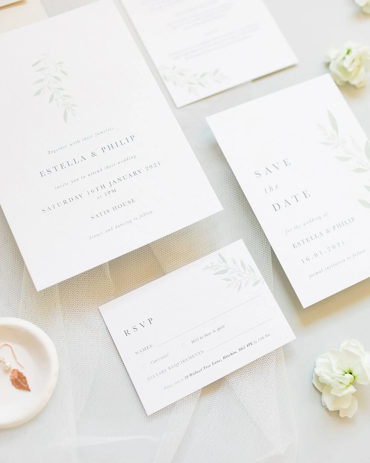 close up of wedding invitation flat lay with invitation, save the date and RSVP card