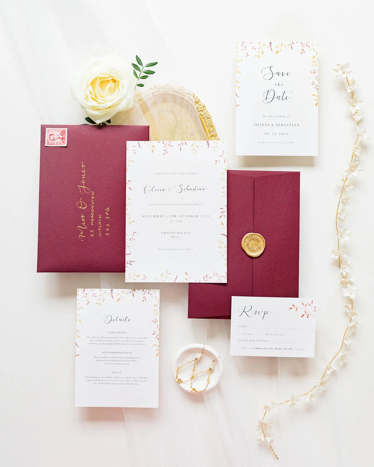 Autumn wedding invitation flat lay with 5x7 invite, A6 save the date, details card and RSVP card, styled with burgundy envelopes and gold wax seals
