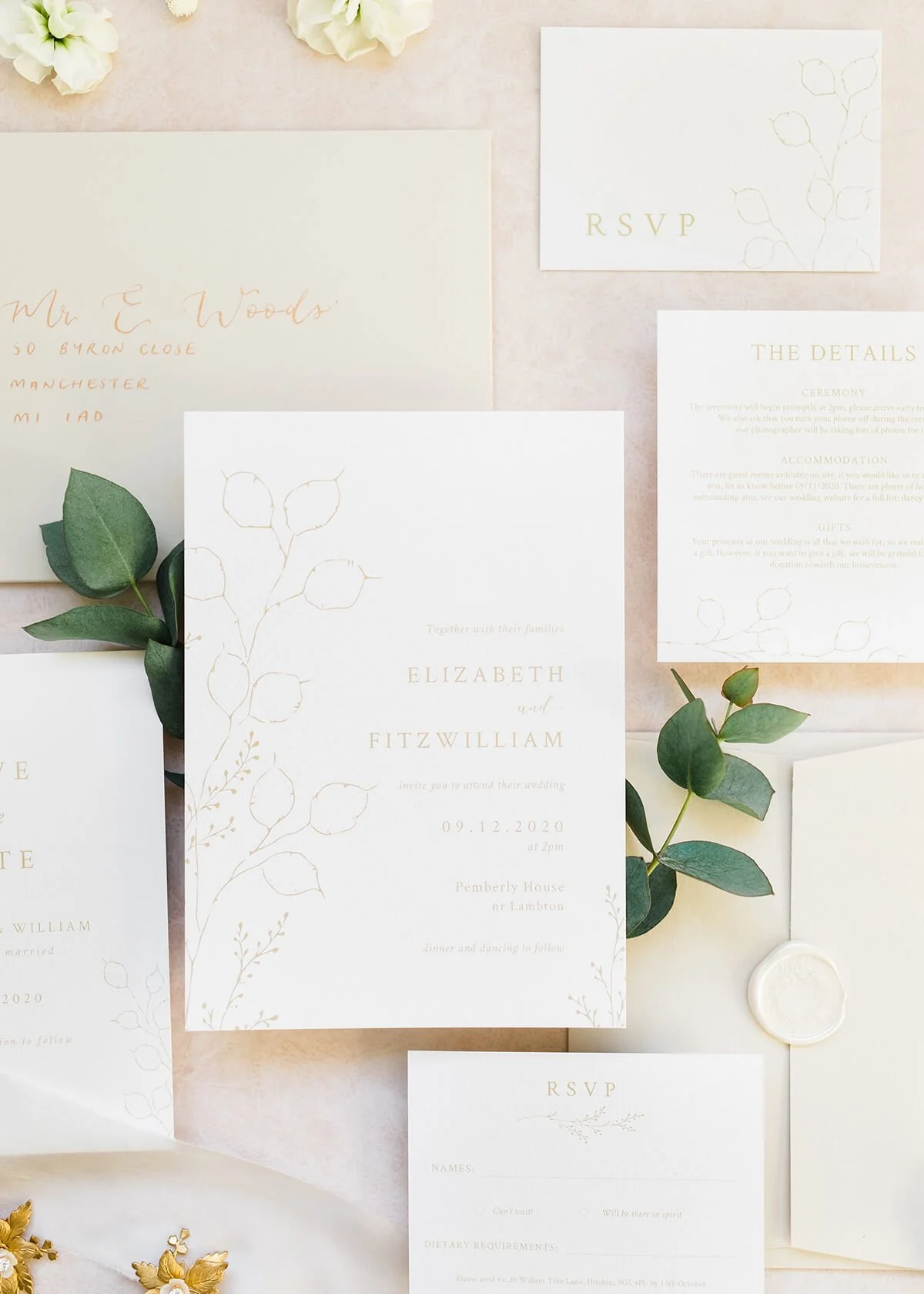 close up of styled wedding stationery flatlay with 5x7 invitation with winter botanical illustrations
