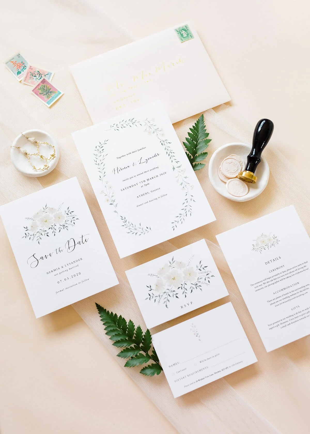 wedding stationery flat lay with 5x7 watercolour wreath invitation