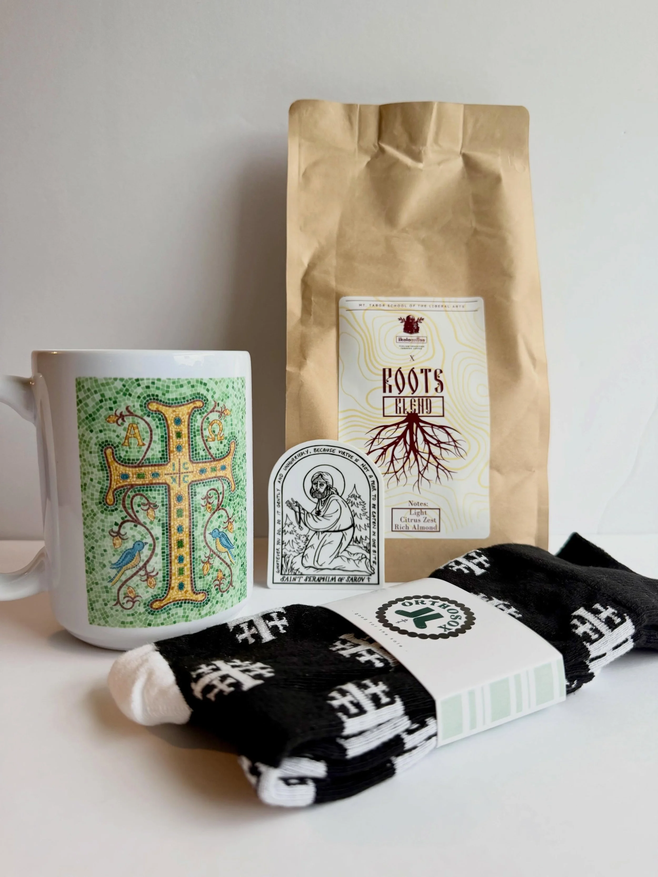 Father&rsquo;s Day Bundles are here! A pound of delicious @skolacoffee, a mug (microwave and dishwasher safe!), a vinyl St Seraphim sticker, and a pair of OrthoSox! 
On sale for $15 off right now! Find it in the Gifts + Special Occasions section of o