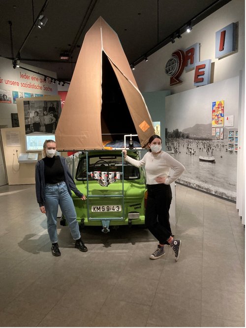 Emely and Theresia planning their next holidays with an original GDR-Trabbi