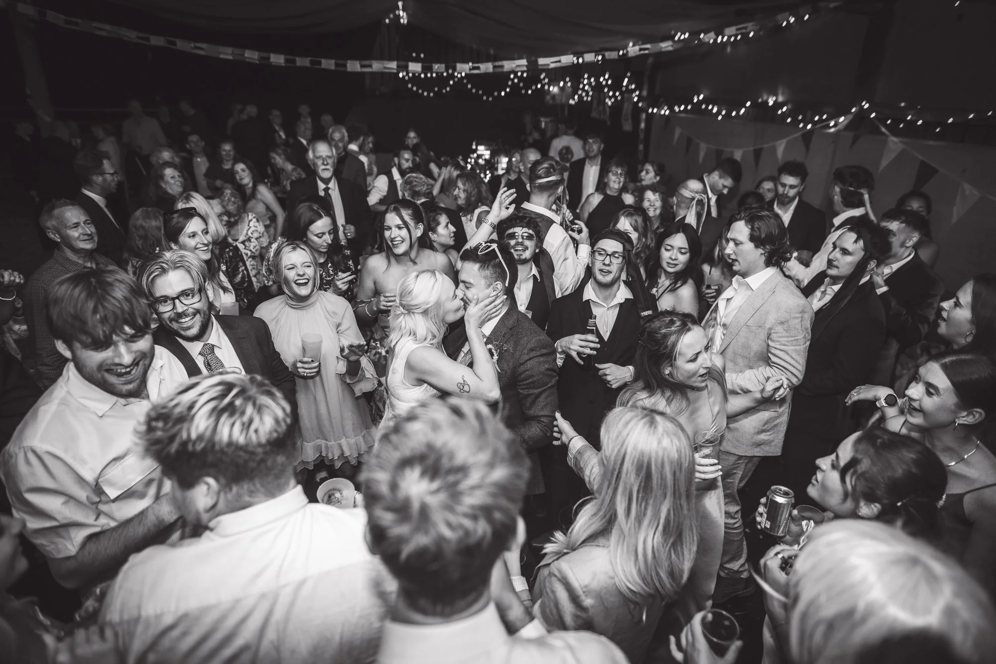 bride-and-groom-kiss-on-dancefloor-Devon-DIY-wedding.jpg