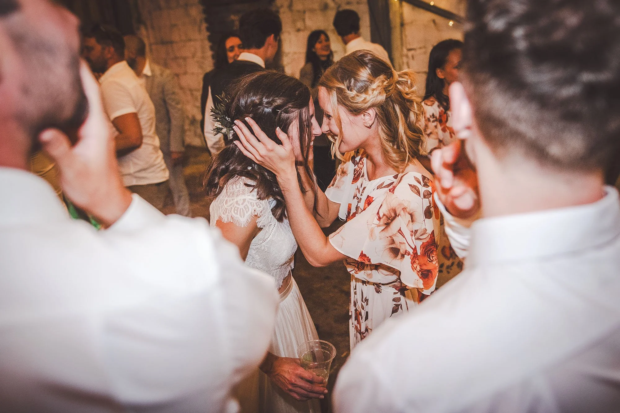 bride-and-bridesmaid-embrace-on-the-dancefloor-East-Soar-Farm-Devon.jpg