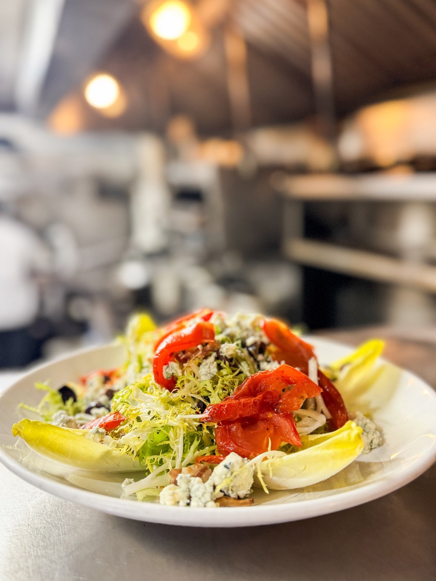 Fris&eacute;e with crisp endive &amp; roasted tomatoes. Grilled striped bass with avocado salsa. Simple, fresh specials from last night 🌿🐟 at Island 🏝️