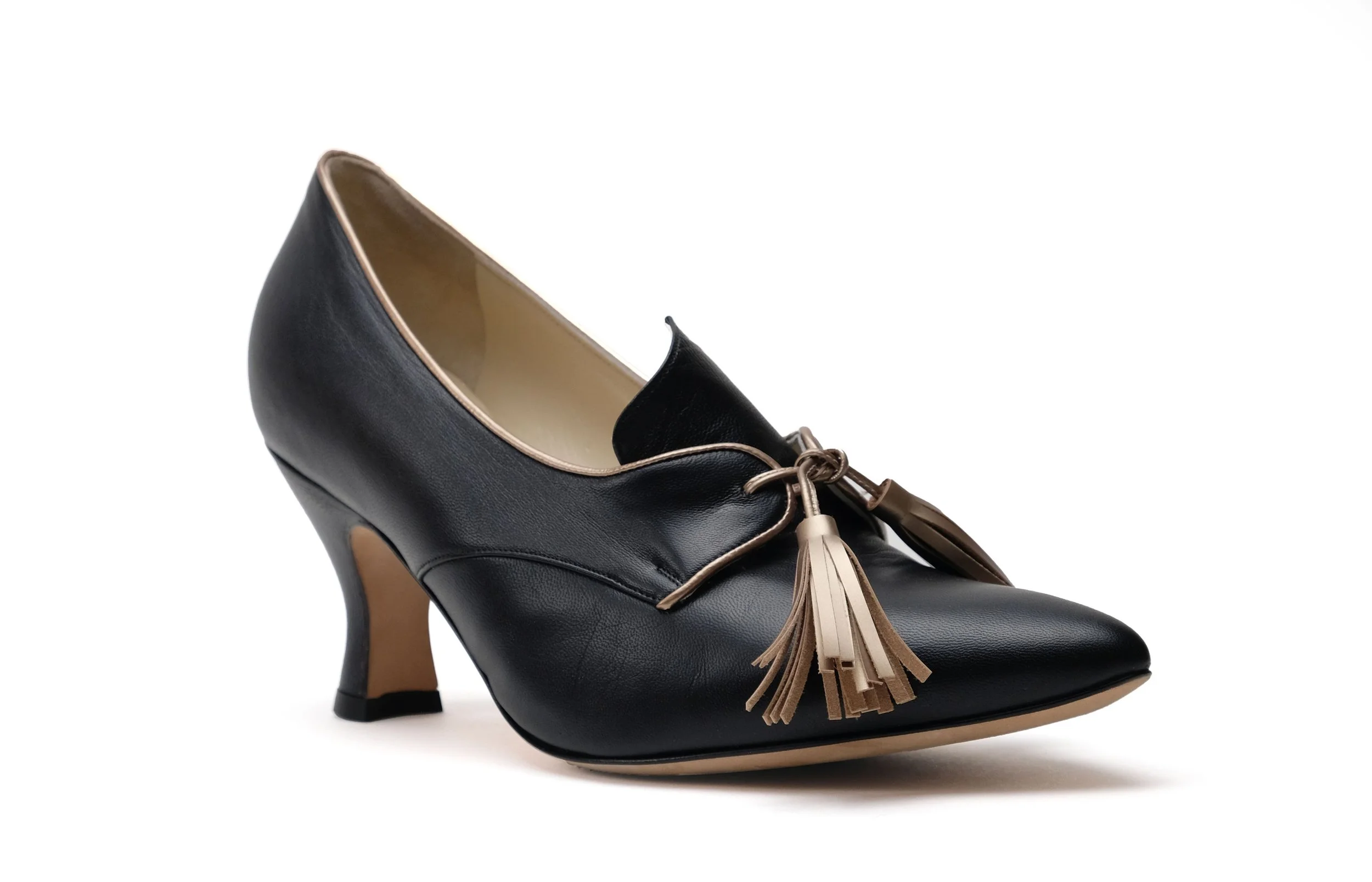 Casey black platinum leather pump front angle gold tassel and platinum piping detail