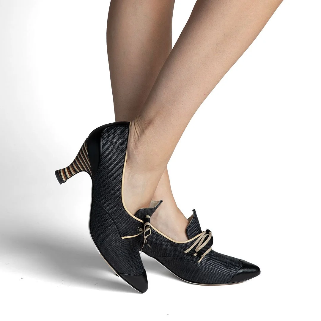 Casey black raffia pump worn side view sculpted stripe heel taupe trim