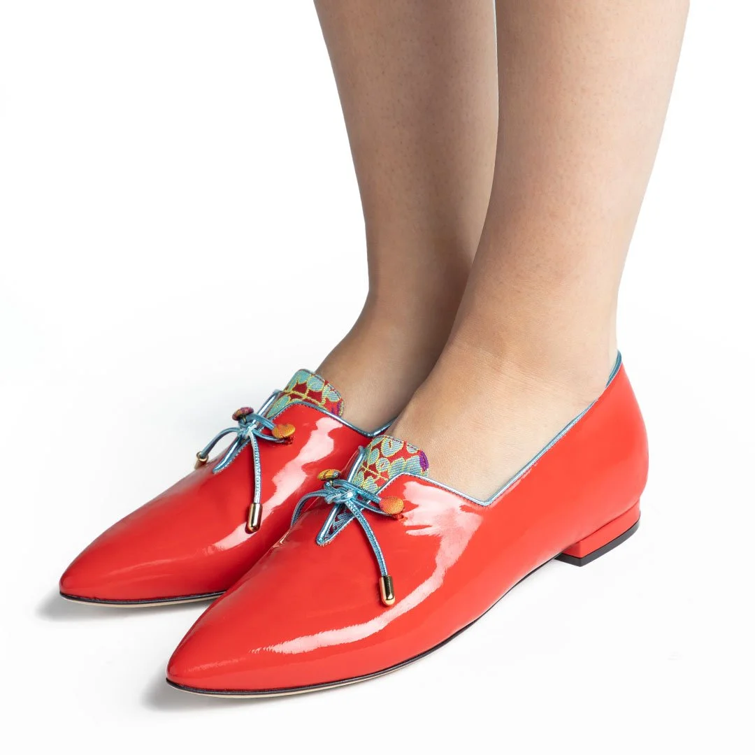 Shelley red patent leather luxury flat worn front view multicolor fabric tongue blue trim lifestyle