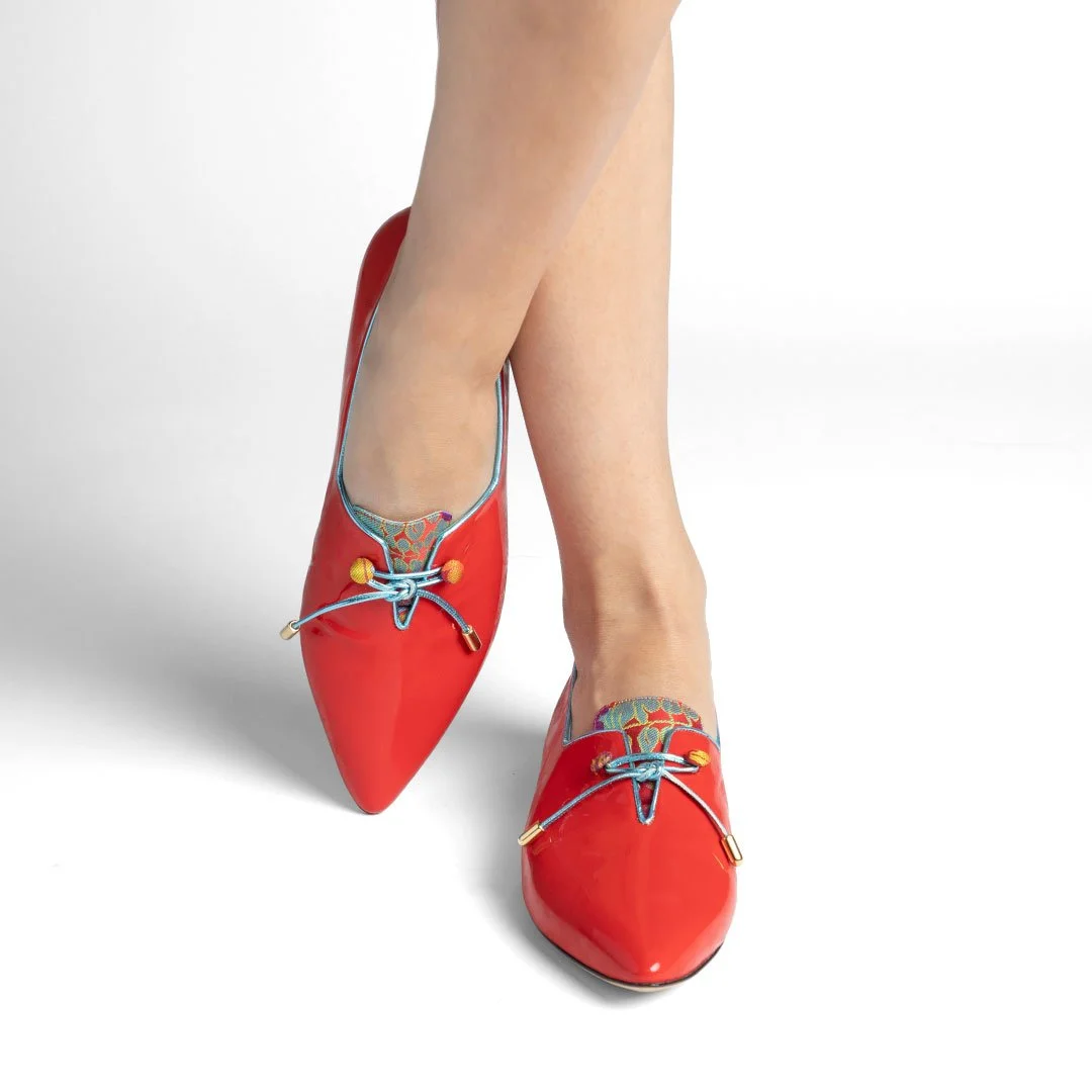 Shelley red patent flat overhead close-up multicolor fabric tongue blue kid leather trim gold hardware detail