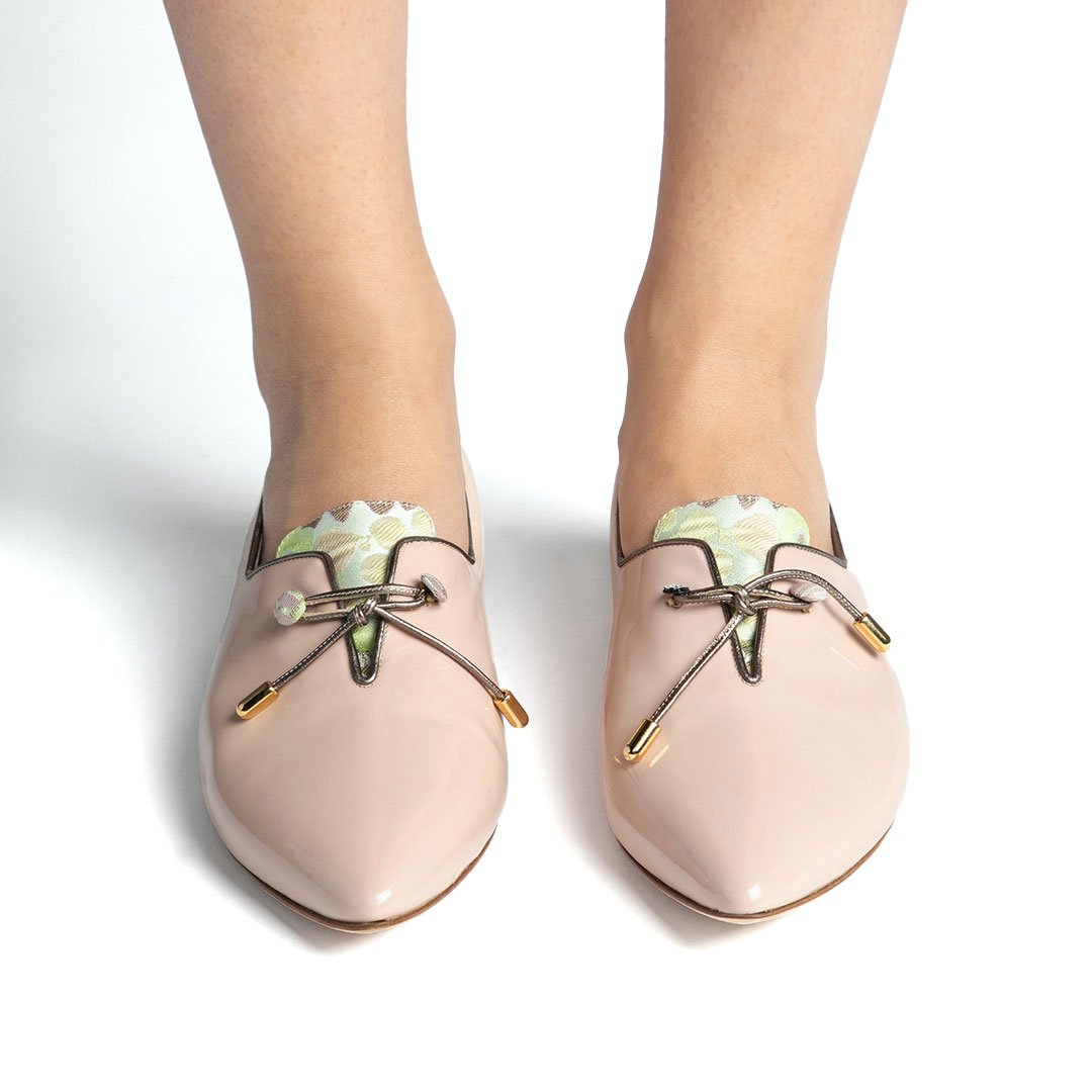 Shelley nude pink patent flat overhead close-up fabric tongue kid leather trim gold hardware detail