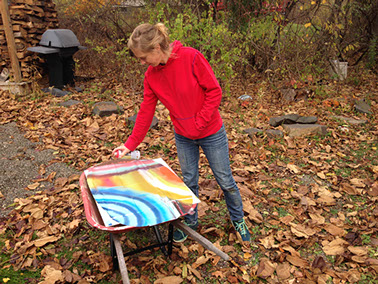 Lisa Sanditz spray painting outside her studio in Tivoli, NY. Photo by Tim Davis, courtesy the artist.