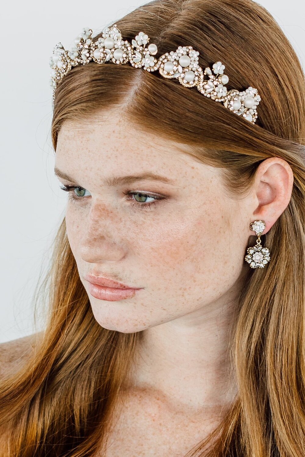Bridal model wearing a pearl and gold bridal crown designed in Miami, FL