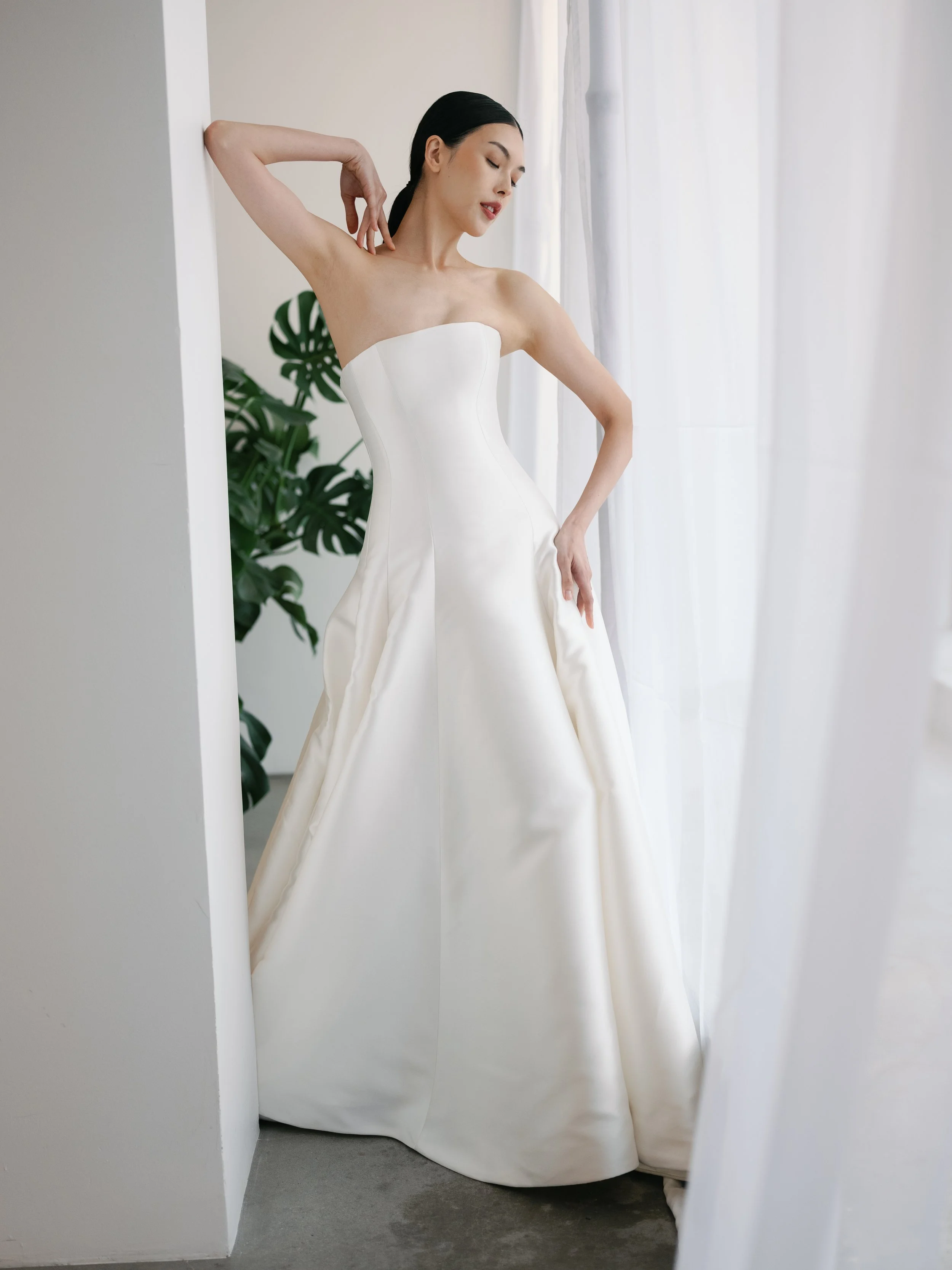 Clean strapless KYHA drop waist wedding dress. A-Line drop waist wedding gown by KYHA. KYHA waterlines collection
