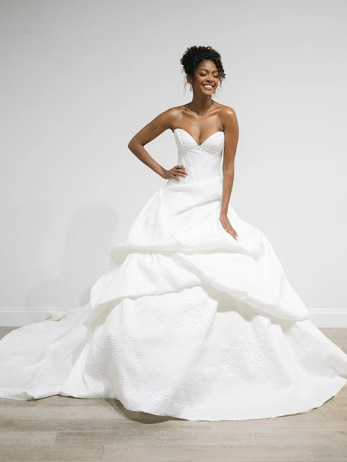 Strapless drop waist dramatic skirt wedding dress. Ball gown wedding dress with sweetheart neckline and jacquard floral print. Dramatic drop waist with full skirt with pick up layers ballgown wedding dress in winter park. Low back ballgown dress