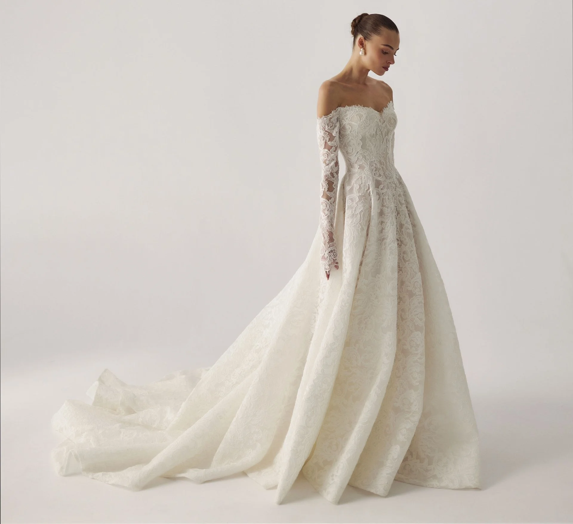 Long sleeve lace wedding dress with basque waist. Lihi Hod Sophia dress in Winter Park Florida. off the shoulder long sleeve lace a-line wedding dress