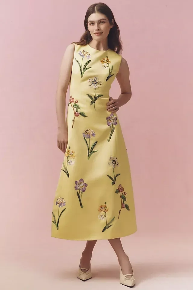 Floral A-line midi dress with a round neckline and fitted waist for spring wedding.