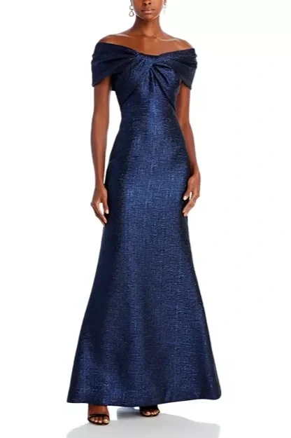 Metallic jacquard twist bodice off the shoulder gown in an A-line silhouette.