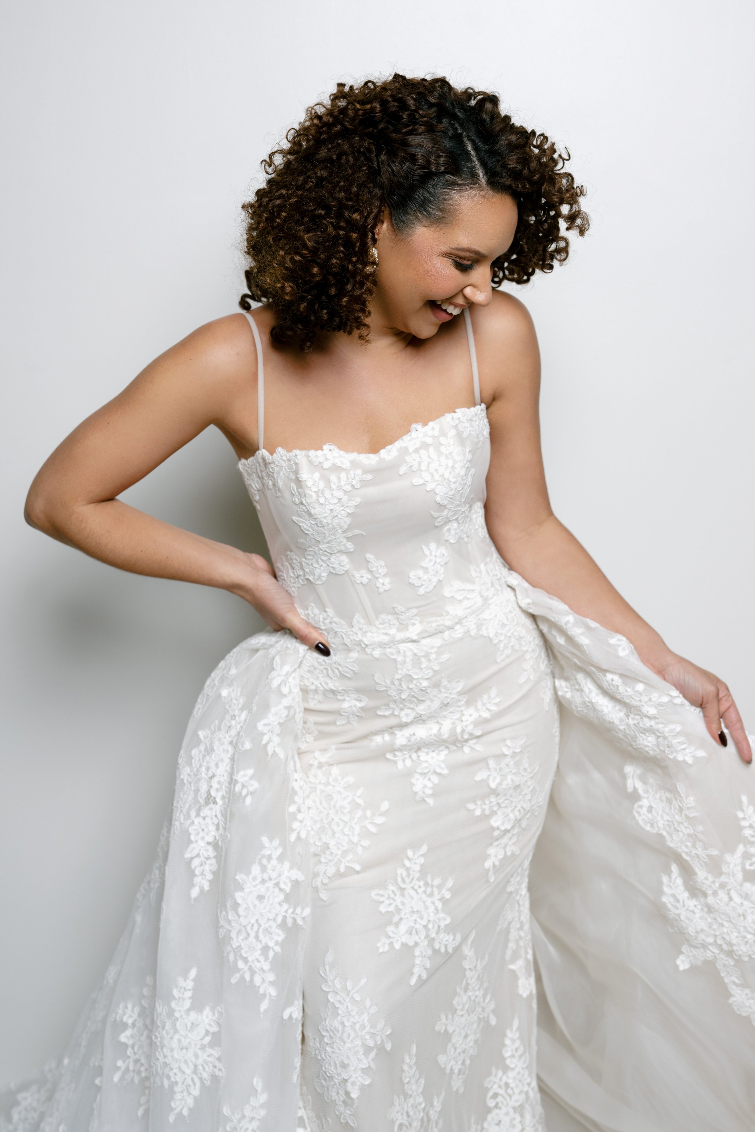 Lace fitted wedding gown with straps. Lace fitted wedding dress paired with a matching removable lace overskirt. Ines Di Santo lace wedding gown in Winter Park bridal store