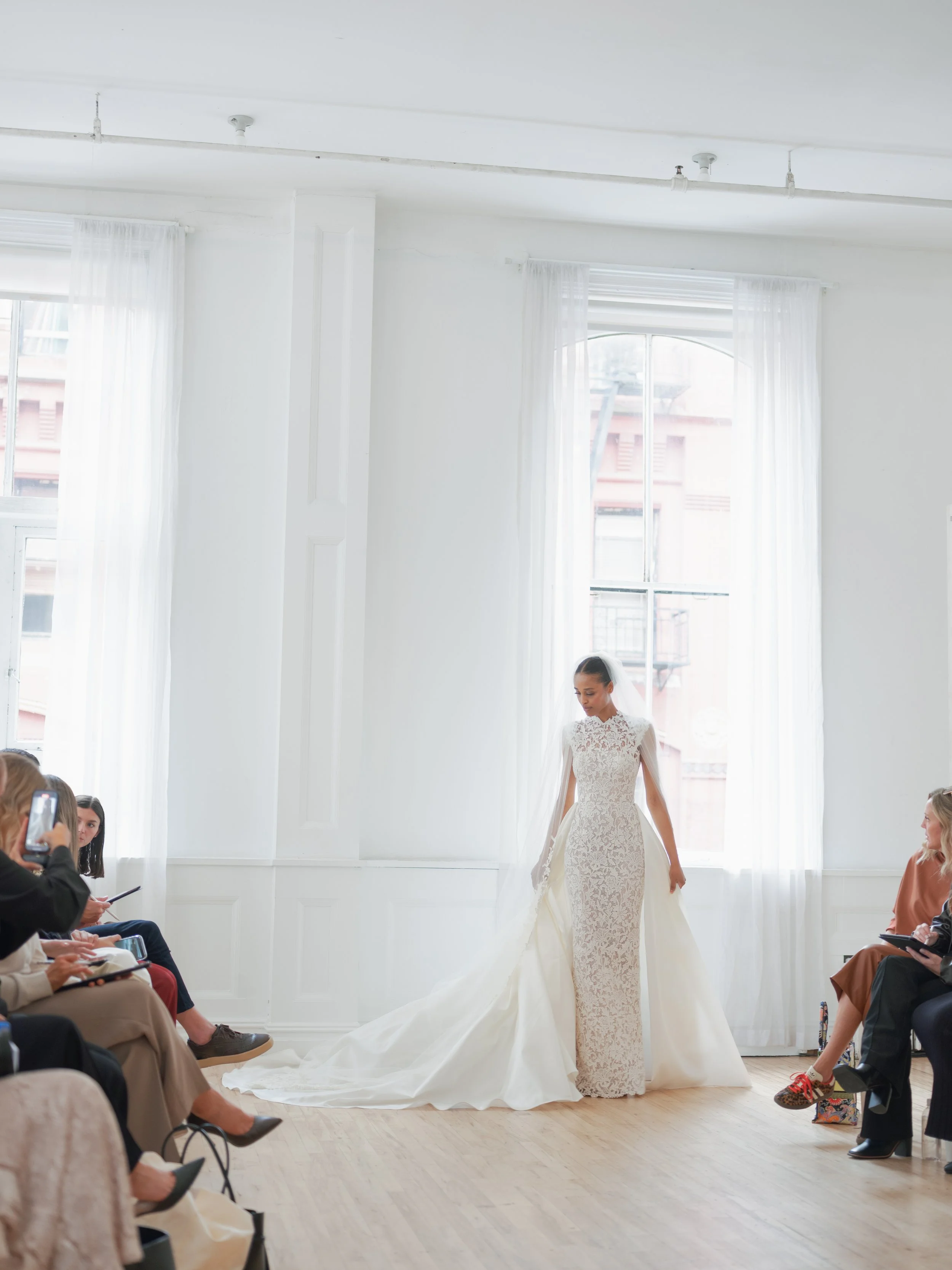 Autumn gown with overskirt by ines di santo. Lace high neck wedding dress with over skirt. Lace halter neck fitted wedding going at new york fashion week.
