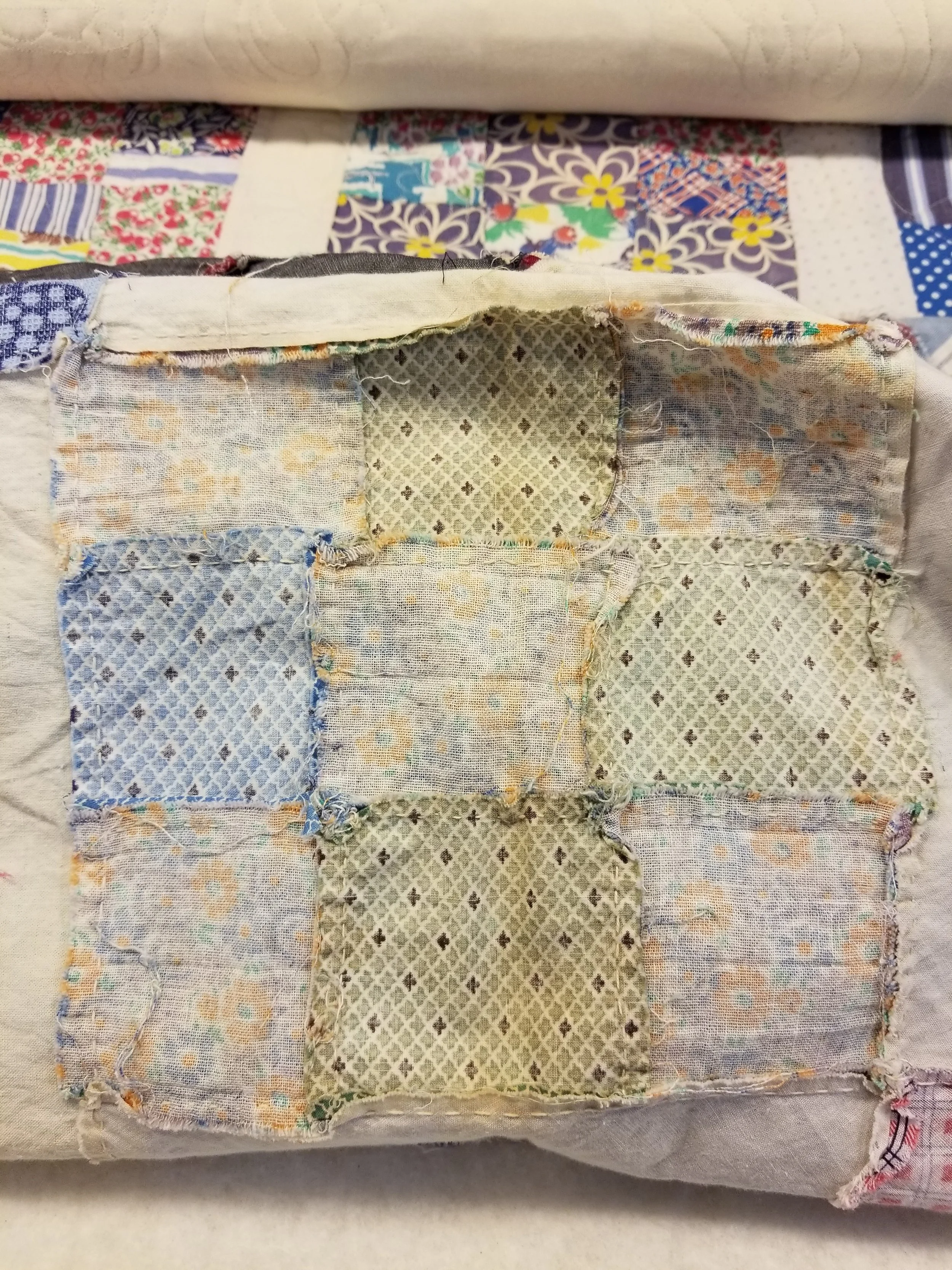 Amazing piece work with the top and just beyond it (top of photo) the quilted back as it rolls on the long arm.