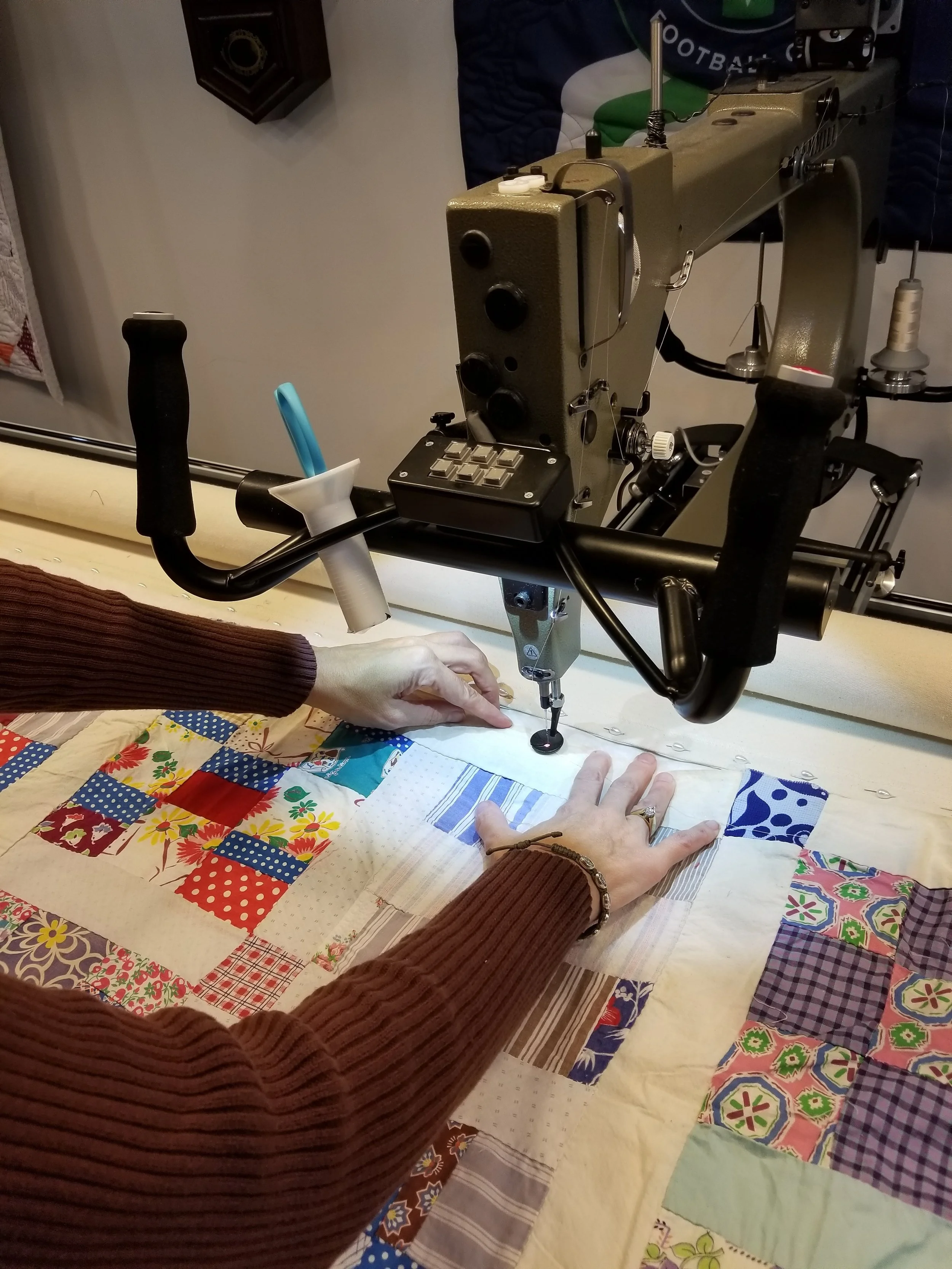 The top being basted so quilting can begin.&nbsp; Notice the variety of fabrics used to make the blocks.