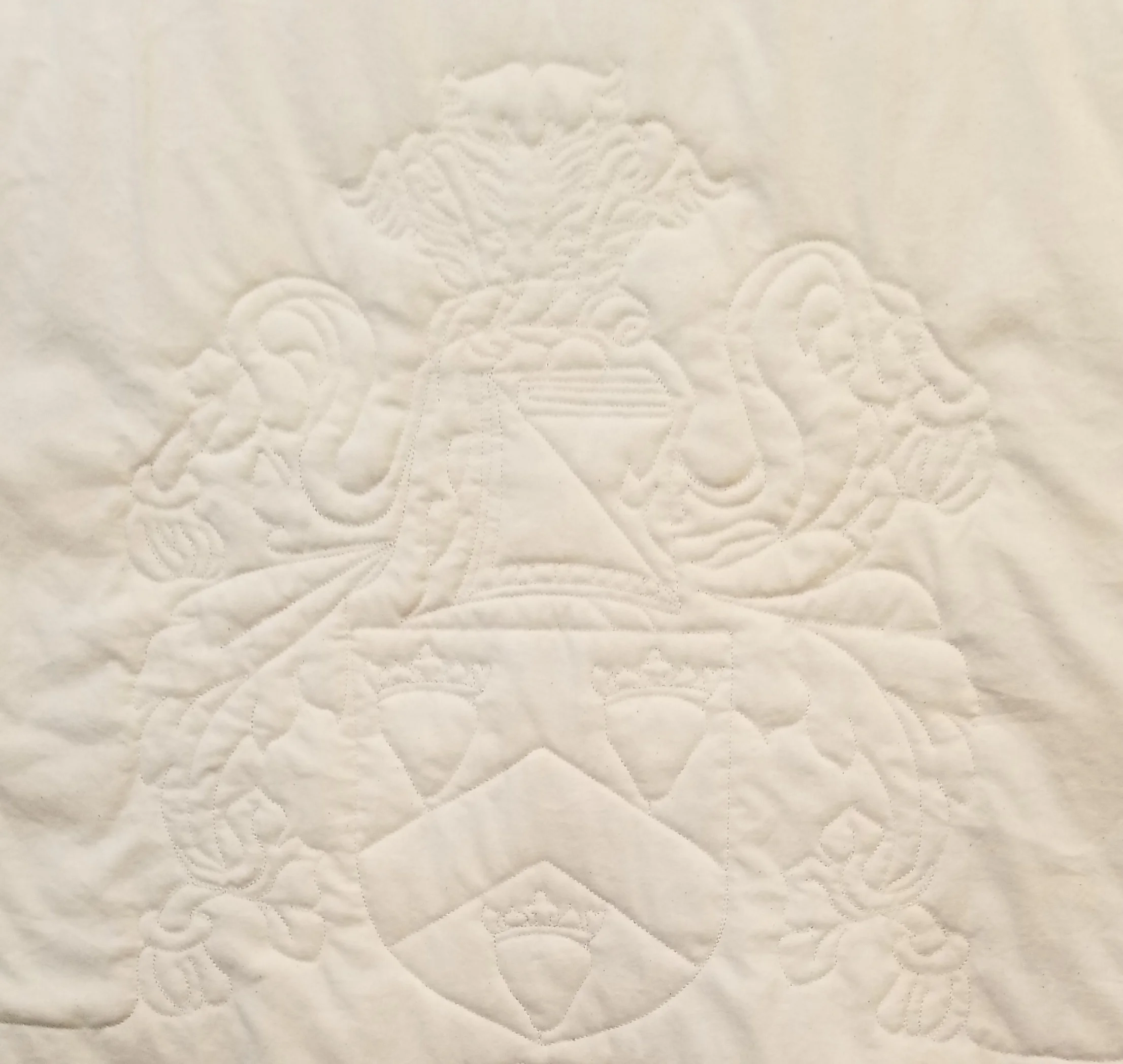 Beth's family crest replicated on her quilt.