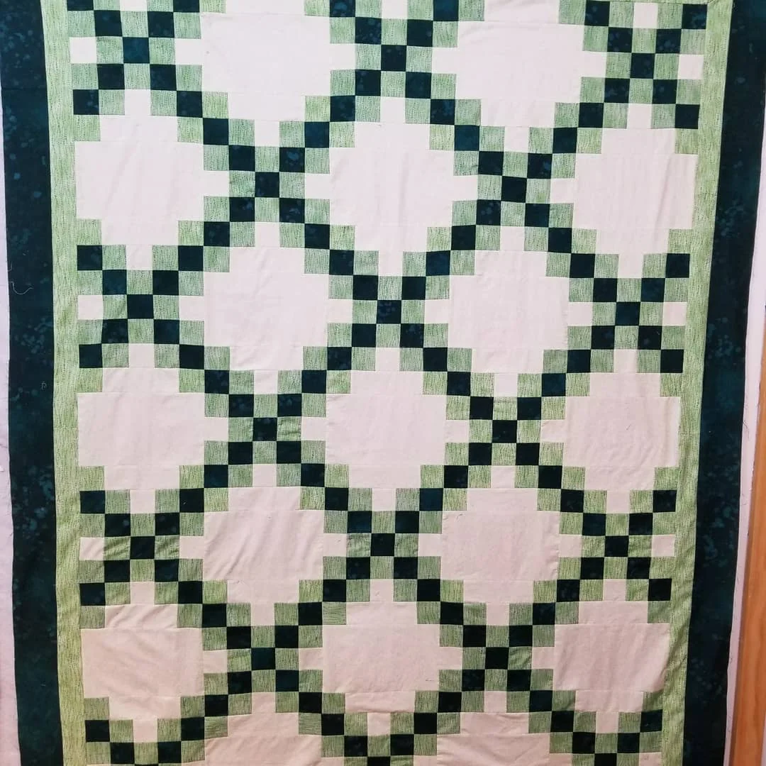 The first block is defined by the strong "X" that is created by two diagonal rows of squares running from corner to corner. The alternate block provides some negative offset to complete the design.